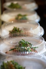 scenes from commercial kitchen preparing food for take away and delivery