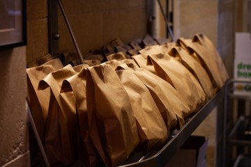 scenes from commercial kitchen preparing food for take away and delivery