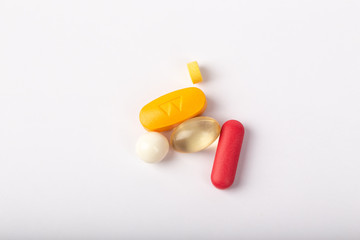 Close up of medicines pills and tablets on white background.