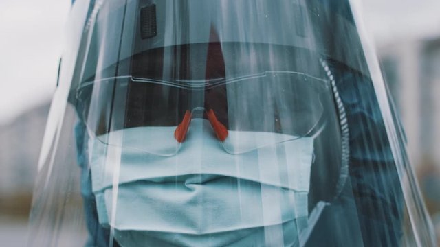 Close up, african man wearing NBC personal protective equipment ppe suit, mask, goggles and face shield. Preventing coronavirus spread