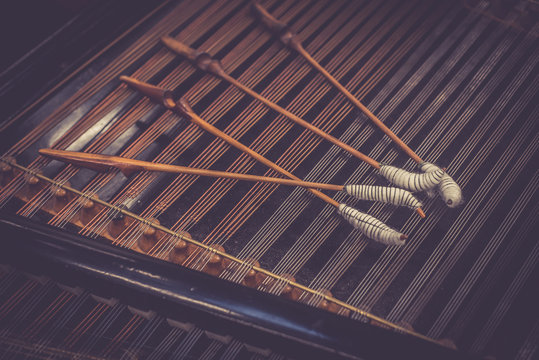 Antique violin and violin bow lying on dulcimer. Close up a violin instrument and cymbal