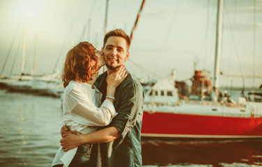 Romantic concept. Young couple in love at sea on a background of yachts club. Youth Lovestory