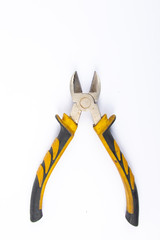 Side cutters with yellow and grey handle on white background.