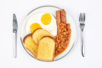 English breakfast with fried eggs, sausages, beans and toasts on white background.