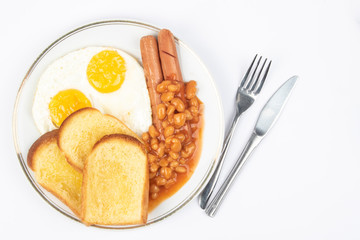English breakfast with fried eggs, sausages, beans and toasts on white background.