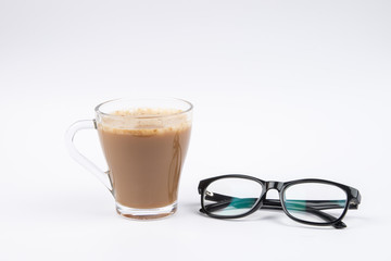 Cup of coffee and eye glasses are isolated on white background