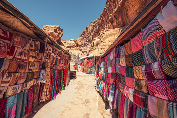 Shopping street with market in the ancient city of Petra in Jordan with souvenir products, fabrics...