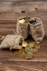 sack bag with Malaysia Ringgit coin on wooden table.- Saving Concept