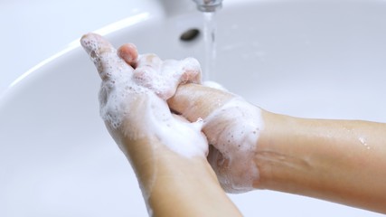 Concept of health cleaning and preventing from Coronavirus or COVID-19 pandemic prevention wash hands with soap and warm water rubbing fingers washing frequently or using hand sanitizer gel