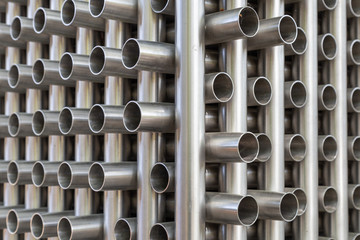 Background with a collection of stacked metal pipes