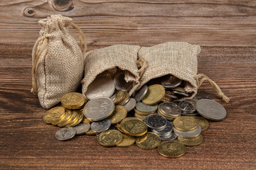 sack bag with Malaysia Ringgit coin on wooden table.- Saving Concept