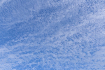 Blue sky background with white clouds on sunny day.