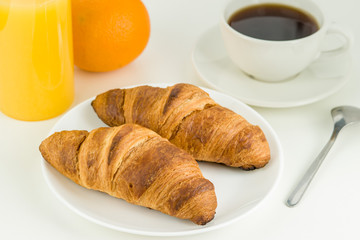 Cup of coffee, juice, orange and two croissants, Breakfast