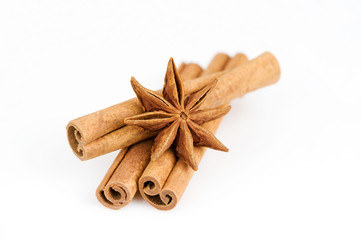 Stars of anise and cinnamon on white background