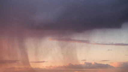Rain streaks from clouds during sunset time