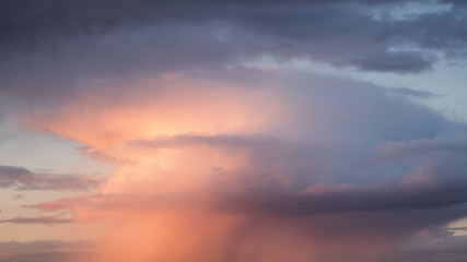 Fototapeta na wymiar Rain streaks from clouds during sunset time