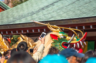 Crowd taking with a smartphone or a camera a huge golden dragon dancing during the festival dedicated to the bodhisattva Kannon in the Sensoji temple of Asakusa.