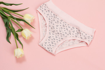 Beautiful women's cotton panties on pink background.