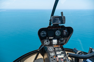 Helicopter cockpit. Great Barrier Reef with blue Sea view. Beautiful aqua & turquoise waters, with coral reef patterns in the ocean. Australia. Flight, vacation, technology.