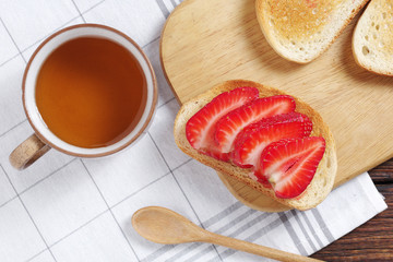 Obraz na płótnie Canvas Toast with strawberry and tea