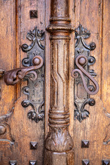 Fragment of old wooden door with rusty handle