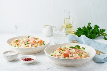Salmon pasta, tagliatelle with fish and creamy sauce. Italian dinner with seafood