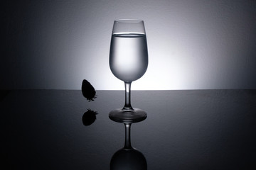 strawberry in a wine glass filled with water.
