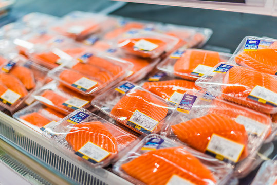 Prepackaged salmon fillets in a commercial refrigerator