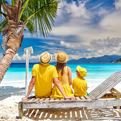 Family with three year old boy on beach. Seychelles, Mahe.