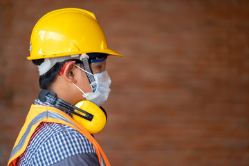 Engineer wear protective face masks safety for Coronavirus Disease 2019 (COVID-19) at construction...