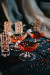 three glasses of red cocktails. Glasses of delicious strawberry daiquiri with rosemary