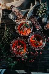 three glasses of red cocktails. Glasses of delicious strawberry daiquiri with rosemary