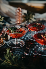 three glasses of red cocktails. Glasses of delicious strawberry daiquiri with rosemary