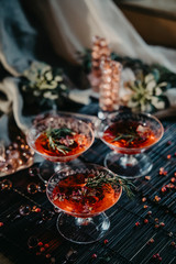 Two-layer cocktail with cranberry vodka, rosemary. Two martini glasses of red alcohol raspberry cocktail 