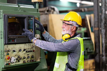 Mechanical Engineering control lathe machine in factory facility. Safety First at work place.