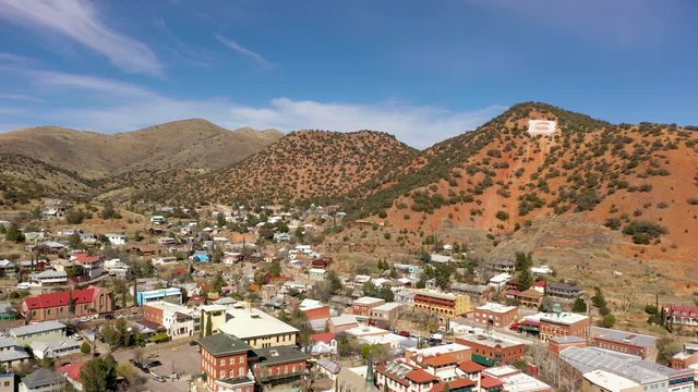 Downtown Bisbee In Arizona, USA Surrounded In Mule Mountain With Blue Sky Above.-  aerial drone shot