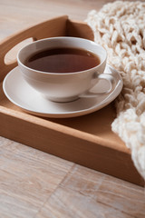 white cup of tea on dotted serving plate. Cup of tea on white marble background. Flat lay with copy space.
