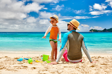 Toddler boy on beach with father