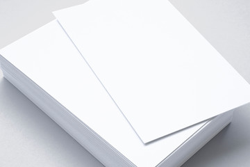 Close view of blank business cards isolated on grey. illustration of vertical stacks to showcase your presentation.