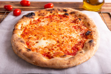 Pizza margherita, Italian traditional dish on a rustic background. Close up.