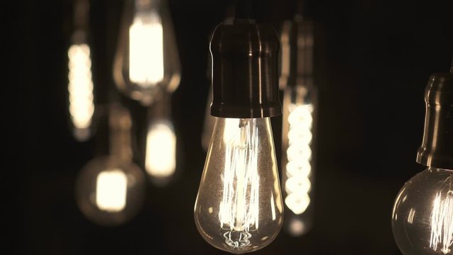 Turning light ON and OFF. Decorative antique edison style light bulbs hanging from the ceiling.