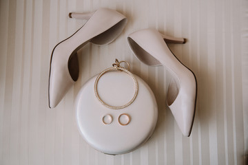 Bridal morning details composition. Top view of wedding rings, beautiful bouquet of pink flowers...