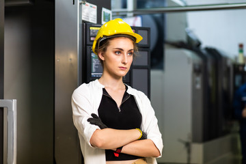Portrait of beautiful woman serious civil engineer wearing uniform and hardhats working at industrial factory. Engineering and architecture concept