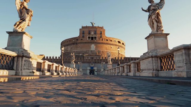 Low Gimbal shot over the Ponte saint'&acute;angelo bridge towards the Castel Sant'Angelo, sunny morning, in Parco Adriano, Rome, Italy