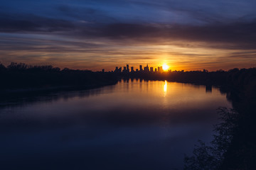 Sunset over city downtown seen from Siekierkowski Bridge in Warsaw, capital of Poland