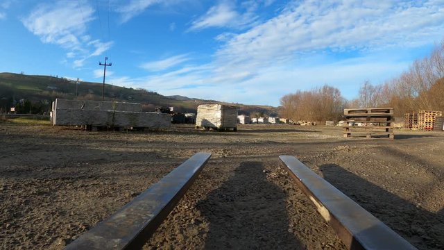 Forklift maneuvering, picking up and lowering stack of pallets