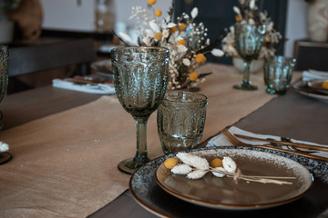 festive table setting. glass dishes. rustic retro style. with flowers.