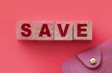 SAVE word on wooden blocks and a wallet. Saving money finance accounting investment concept