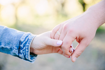 Couple Wife Husband Dating Relaxation Love Concept. Couple hands together touch with love. People, family, care and support concept - close up of young  woman and man holding hands together