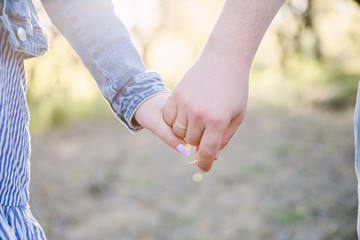 Couple Wife Husband Dating Relaxation Love Concept. Couple hands together touch with love. People, family, care and support concept - close up of young  woman and man holding hands together